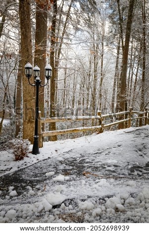 Winter scene of fence and lightpost covered in snow