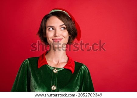 Photo of dreamy thoughtful pretty lady look empty space wear elf costume hat isolated red color background