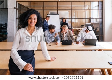 Multiethnic corporate business team meeting in the office for a strategic marketing plan - Office workers, entrepreneurs and company employee at work in a multinational company Royalty-Free Stock Photo #2052721109
