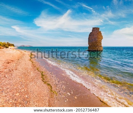 Empty Mylos Beach ruins of old Roman tower on background. Exotic summer scene of Peloponnese peninsula, Voria Kinouria, Greece. Adorable Myrtoanian seascape. Beauty of nature concept background.