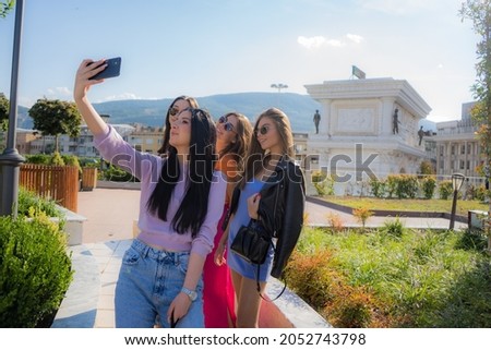 Four beautiful and amzing cute girls are taking pictures together with the sun