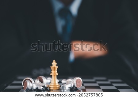 Businessman moves chess with hand.Strategic planning concept about mistakes topple the opposing team and analyze the development for the success of the organization.