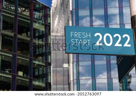 Fresh Start 2022 sign in front of city skyscrapers