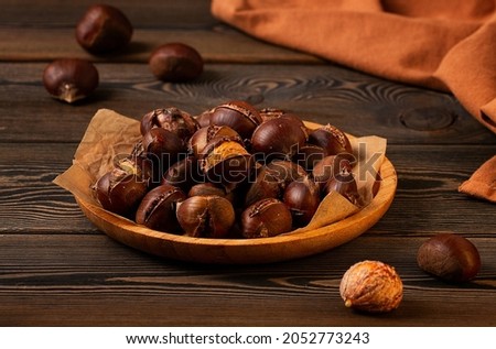 Roasted chestnut, on a wooden table, no people, Royalty-Free Stock Photo #2052773243