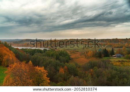 landscape autumn forest, river and cloudy sky. Izborsk settlement,Russia