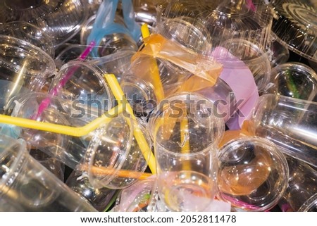 Lots of plastic glasses and straws. Plastic waste.