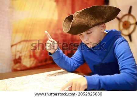 Portrait of boy in cocked hat with map