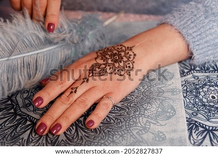 Mehendi tattoo. Woman Hands with henna tattoo