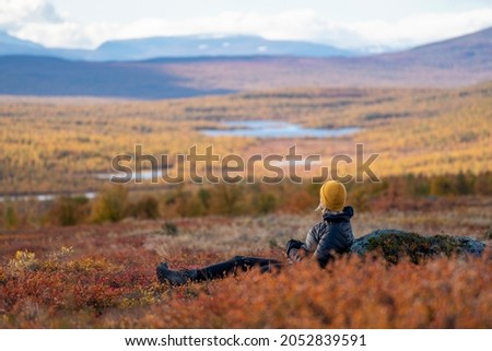 Caucasian outdoor active woman sitting In beautiful Autumn Colors