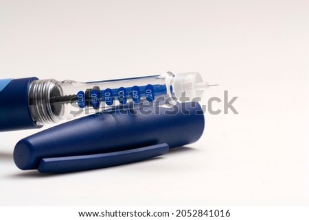 Insulin injection pen or insulin cartridge pen for diabetics isolated on white background with copy space. Medical equipment for diabetes patients Royalty-Free Stock Photo #2052841016