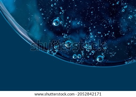 Liquid smear,cosmetics swatch on the blue background.Top view,antibacterial liquid surface.Good as background or mockup. Royalty-Free Stock Photo #2052842171