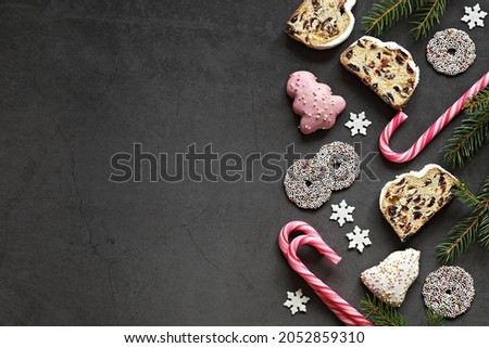 Christmas festive background with German traditional Stollen,  cookies and candy. Overhead view, copy space
