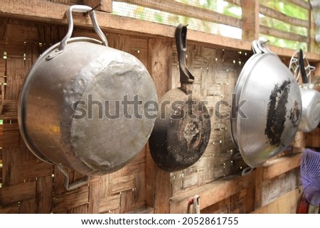 Isolated pots, pans hanging on woven bamboo background(chamber).close view.