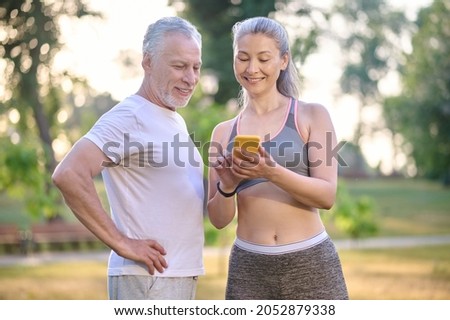 A mature couple checking something online and looking interested