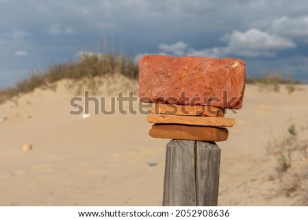 Stones balanced on a wooden post