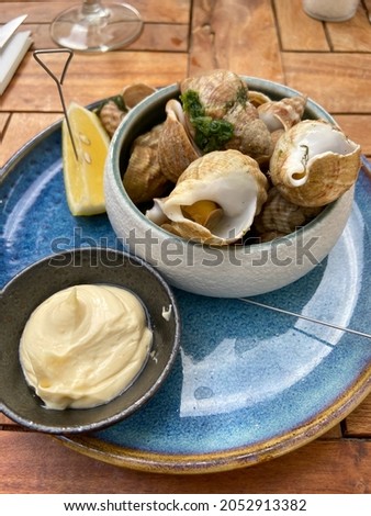 Fresh whelks on a bowl Royalty-Free Stock Photo #2052913382