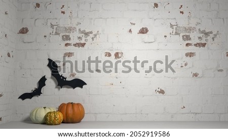 Halloween decorations on a brick wall background, with pumpkins and bats