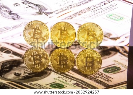 Golden bitcoin on golden background with reflection of virtual money bitcoin BTC