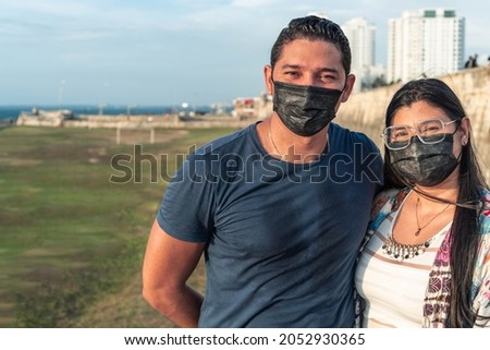 Couple with protective mask sharing in the open air