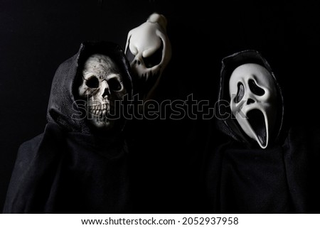 Scary halloween ghouls with scary faces on a black background Royalty-Free Stock Photo #2052937958