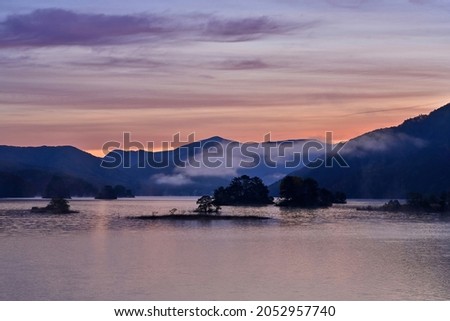 Fantastic blue moment scenery of Lake Akimoto stained in sunrise glow at Fukushima pref.