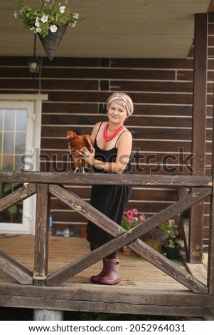 a female farmer at home with a chicken