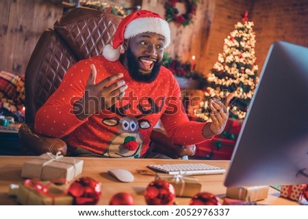Portrait of attractive cheerful guy using computer talking on web chat festal day staying at home loft industrial style interior indoors