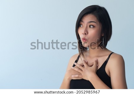 surprised and excited asian woman looking to blank space