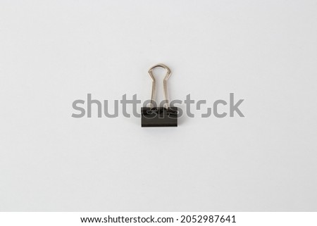 A medium size binder or paper clip on white background