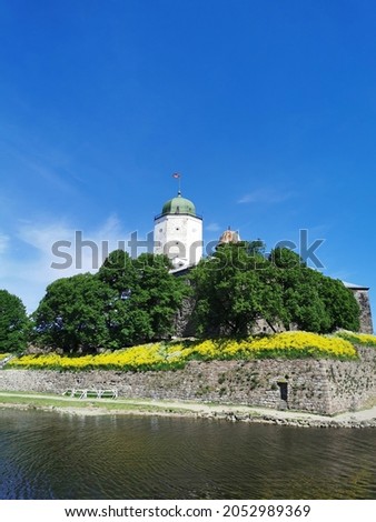 View of Vyborg Castle and St. Olaf's Tower, built in the 13th century, in the city of Vyborg against the blue sky.