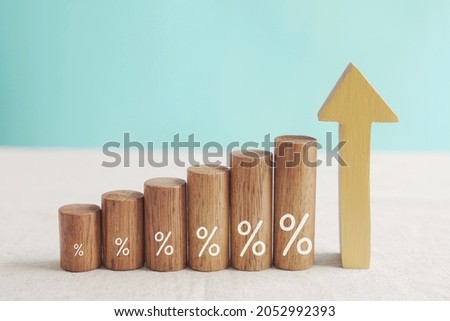 Wooden blocks with percentage sign and arrow up, financial growth, interest rate increase, inflation, high price and tax rise concept  Royalty-Free Stock Photo #2052992393