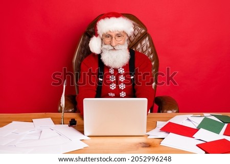 Photo of santa claus happy positive smile chat type email greeting laptop christmas isolated over red color background