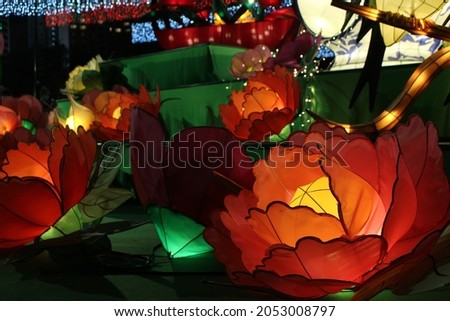 Lighting show to celebrate Chinese Mid Autumn Festival. the picture shows green and red flowers, this lighting fixtures are made by LED.