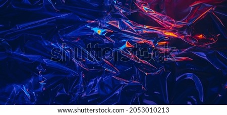 Dark iridescent transparent plastic texture with colorful light Royalty-Free Stock Photo #2053010213
