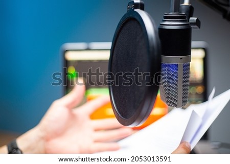 Asian influencers using microphone for podcasts and record sound for upload file to system.Live recording .Speaking online with mobile.Studio audio broadcast.