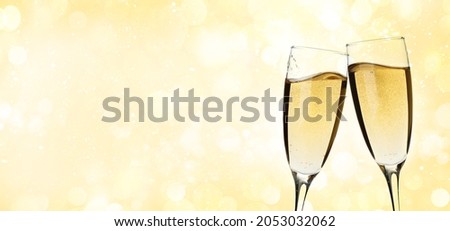 Christmas or Happy Birthday greeting card with champagne glasses and bokeh background. Holiday card with copy space