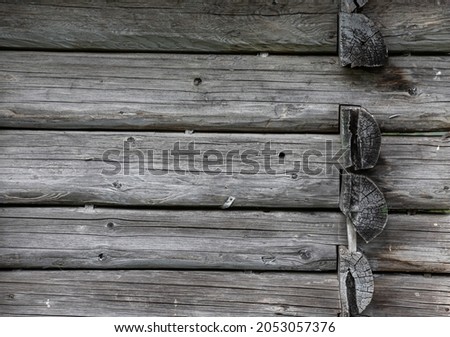 The angular part of a wooden house made of logs. In the picture shows a few logs closeup.