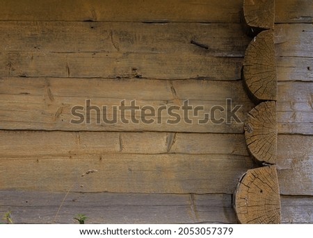 The angular part of a wooden house made of logs. In the picture shows a few logs closeup.