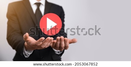 Businessman pressing, hold play button sign to start or initiate projects.Video Play Presentation. Idea for business, technology.media player button. Play icon.Go