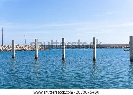 Landscape with cement pillars with background measurement in the bathing area at the Forum in Barcelona Royalty-Free Stock Photo #2053075430