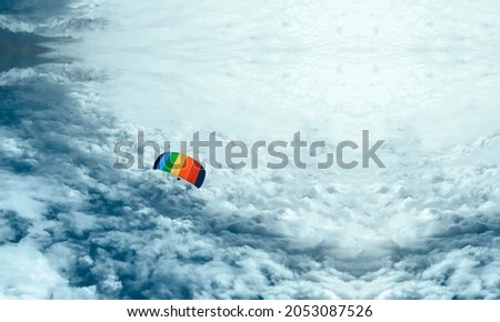 Aerial view of a skydiver from the sky, picture of a skydiver from the clouds with copy space