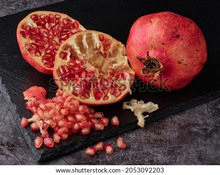 Red juice pomegranate on dark background