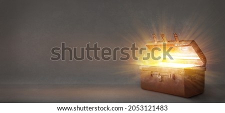 Open an ancient treasure chest that radiated light in old background Royalty-Free Stock Photo #2053121483