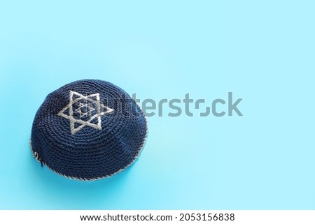 Jewish cap on color background