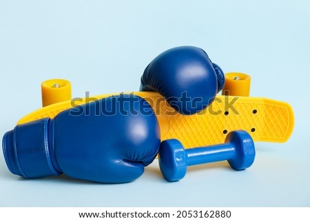 Different sports equipment on color background