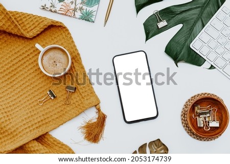 Flat lay mockup smartphone blank screen, a cup of coffee on a white background