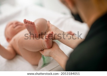 Pediatric patient being tested for neonatal reflexes Royalty-Free Stock Photo #2053184051