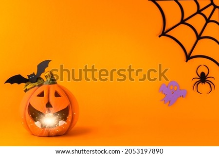 Happy halloween holiday concept. Jack o lantern, handmade paper decorations, spiders, web, ghosts, bats on orange background. Halloween festival party, greeting card mockup with copy space.