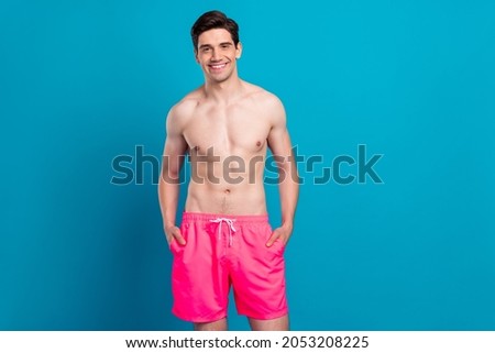 Photo of young handsome man happy positive smile confident cool swimwear isolated over blue color background Royalty-Free Stock Photo #2053208225
