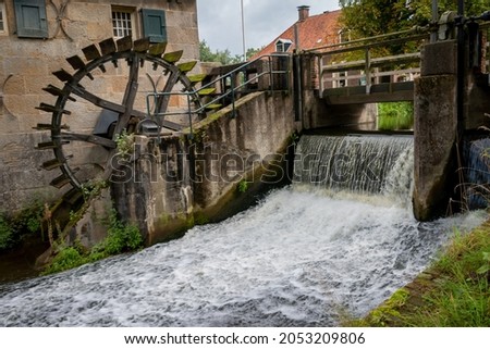 The old water mill named 'Mallumse mill', for processing corn and oil, near the village of Eibergen in the region 'Achterhoek', province of Gelderland, Netherlands Royalty-Free Stock Photo #2053209806